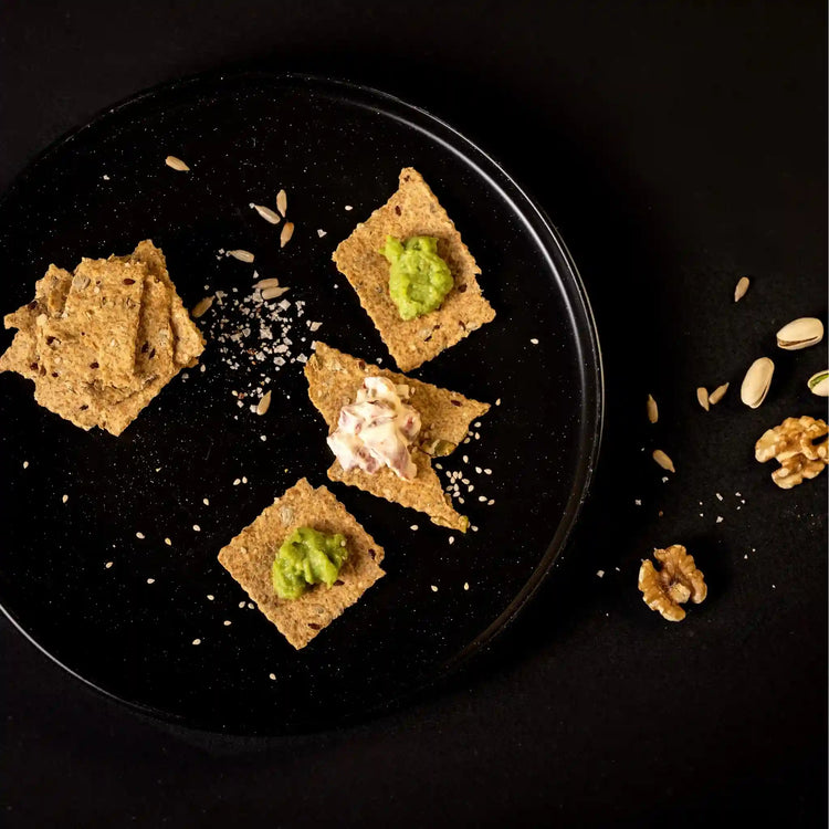 Seeds & Sea Salt Crackers on a plate with assorted food items